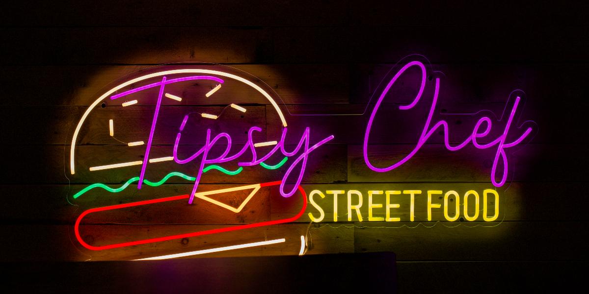 Neon Tipsy Chef Street Food sign.