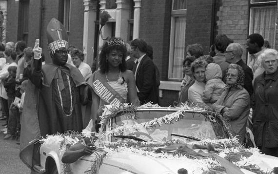 1980s Caribbean Carnival Queen riding in car during parade. Photo credit: Lancashire Evening Post