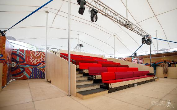 The MET tiered seating area with decorated walls behind.