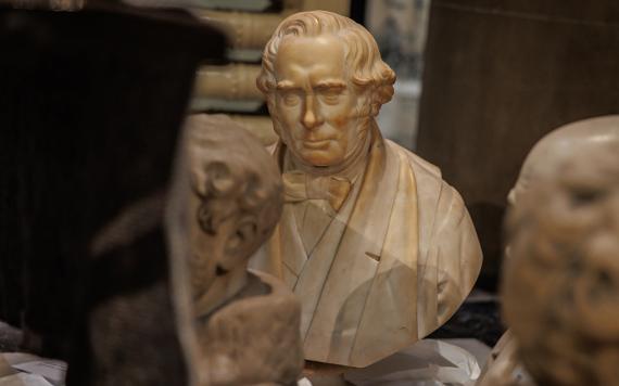 Close up of bust from The Harris' collection arranged around other busts on floor ready for storage.