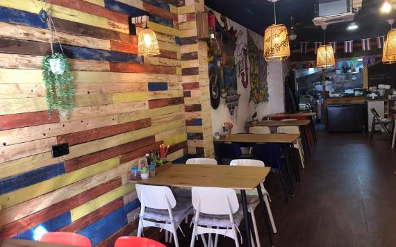 Itsy's Street Food main seating area with paper lanterns and colourful wall panelling