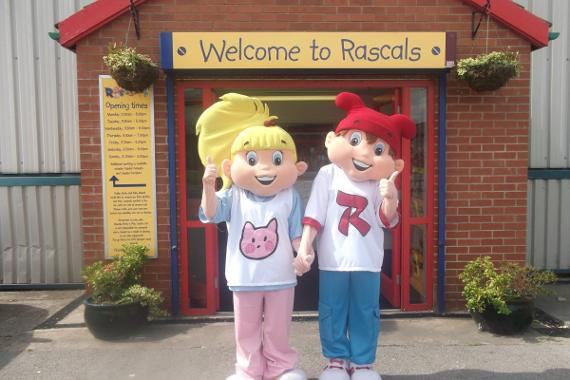 Rascals Party and Play Centre Mascots outside the entrance posing for a picture