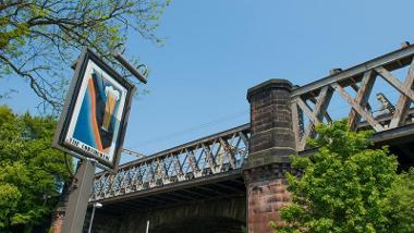 The Continental Pub's sign with bridge in background