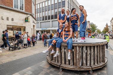 Performers sat on the giant wheel