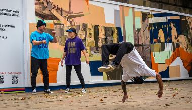 Person break dancing on the Flag Market