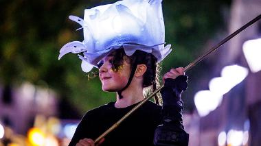 Girl with illuminated hat in torchlight procession