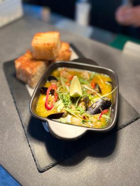 A close up of the Shrimp Bobo seafood dish served with focaccia