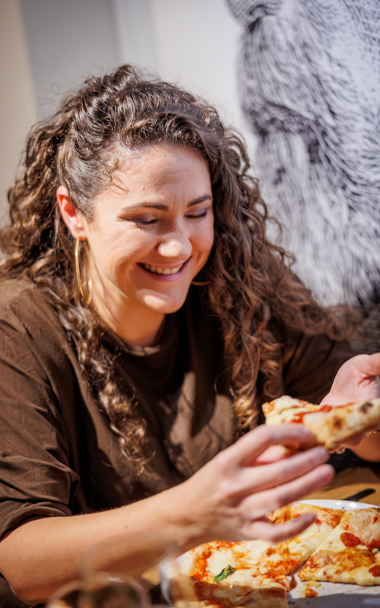 Lady eating pizza