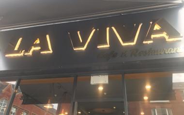 A closer look at the glowing sign under the awning of La Viva