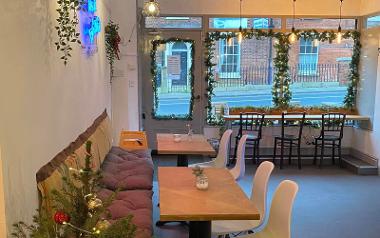 Seating area and large window looking out of Origin Bakehouse