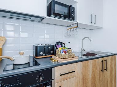 A City Studios Preston studio room kitchen with an oven, electric hob, toaster, kettle, sink and microwave