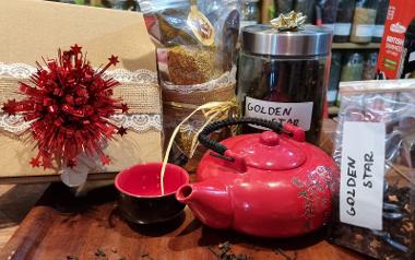 A tray with a red teapot and containers of tea leaves from The Tea House Preston