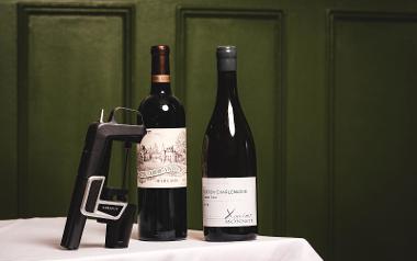 Two bottles of wine and an electronic wine bottle opener from Aven Restaurant