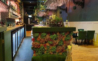 The bar counter inside Florianas Restaurant and Bar decorated with flowers