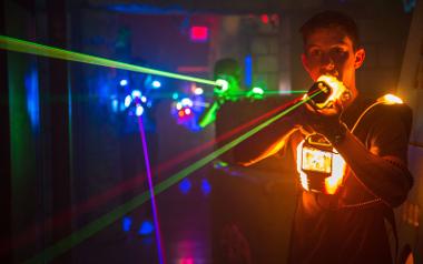 A boy with an orange laser gun exited while playing a game inside Laserforce Preston