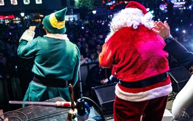 Santa and his Elf cheer with microphones to an excited crowd at Preston Christmas Lights Switch On 2022