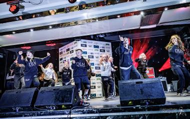 A group of child singers and dancers perform on stage at Preston Christmas Lights Switch On 2023