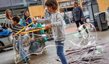 Boy creating a giant bubble