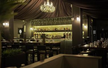 A view of the bar area inside Forum decorated with fairy lights and a chandelier