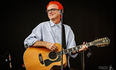 Fran Healy playing guitar on stage