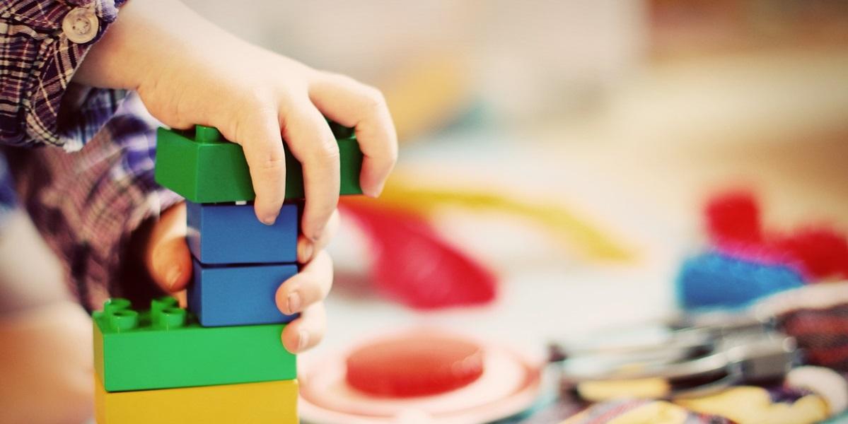 Close up of child playing with colourful blocks