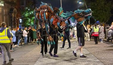 A group of people holding a Dragon in the Encounter Parade 2024