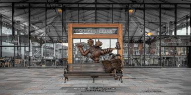 Entrance to Preston Market Hall with Wallace and Gromit statue in front.