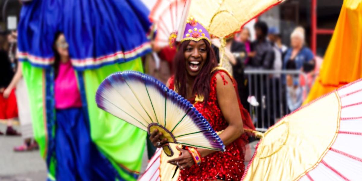 Woman dressed in colourful costume whilst attending Preston's Caribbean Carnival.