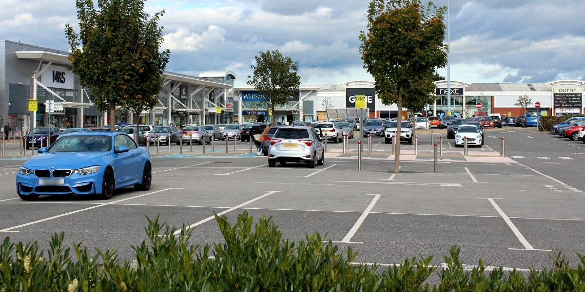 Car park area and stores at Deepdale Shopping Park.