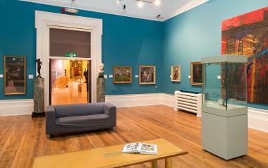 Sofa and table with magazine on in art gallery in the Harris Museum.