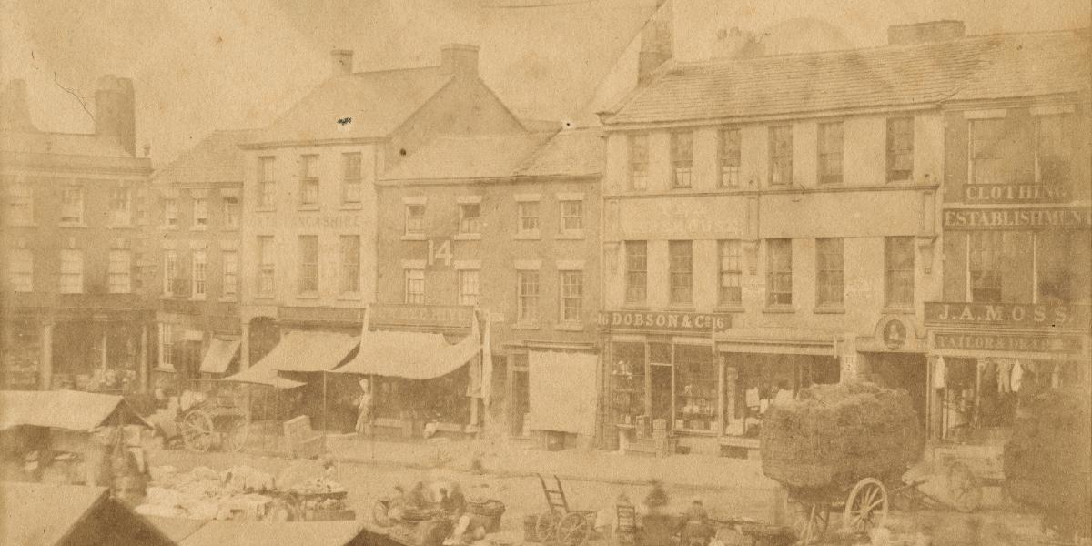 Old photograph of Preston Market Square with traders and shops operating on and around it.