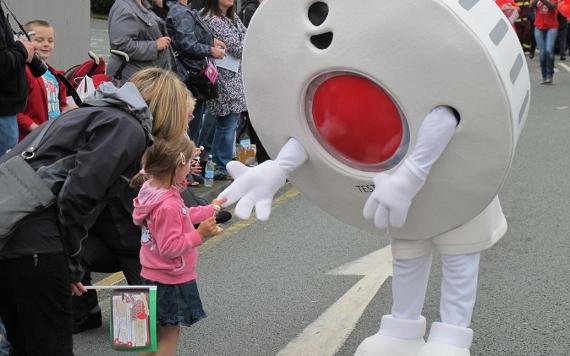 Person in costume as a fire alarm in Preston Fire Brigade community procession.