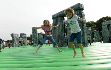 Children bouncing on inflatable Stonehenge.