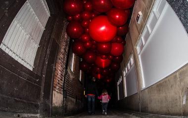 Father and daughter walking under red lights at Lancashire Encounter