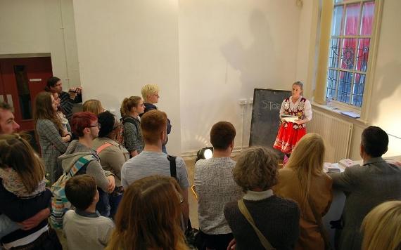 People gathered around a performance taking place inside the Birley.