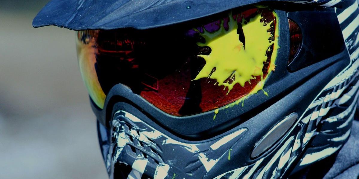 Close up of paint splattered paintball mask.