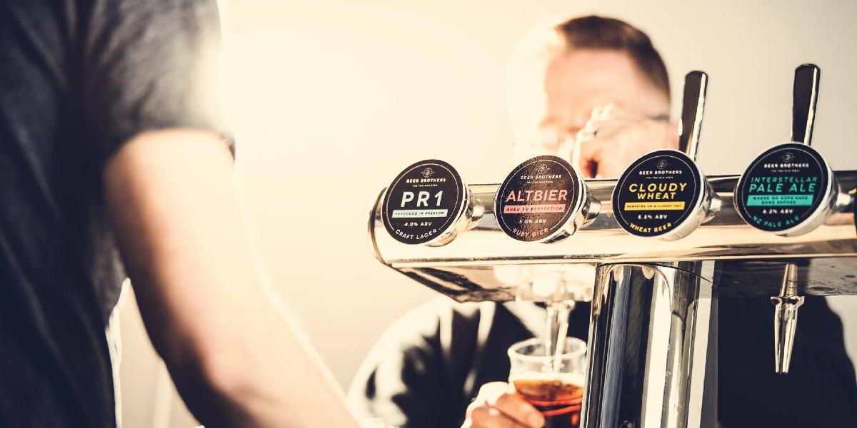 Barman pulling pint at Beer Brothers Brewery.