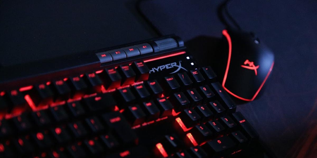 Close up of gaming keyboard and mouse backlit with red l.e.ds. 