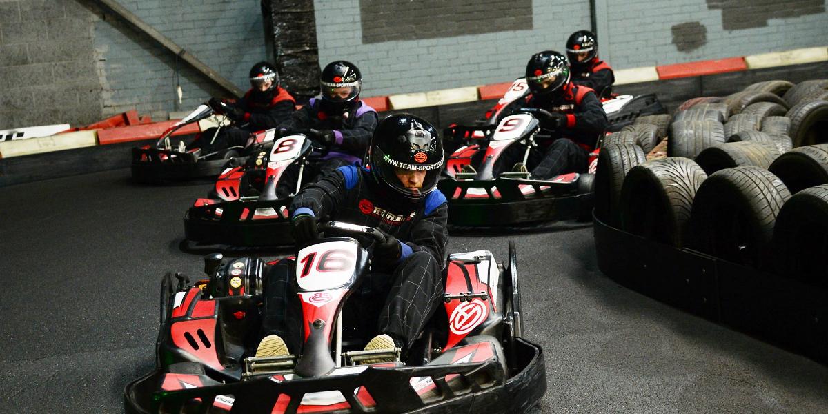 Go karts racing around TeamSport Go Karting track.