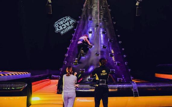 Girl climbing inflatable climbing wall at Wacky World.