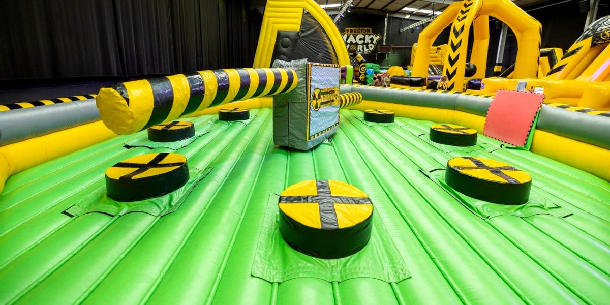 Inflatable wipeout zone with other inflatables in the background.