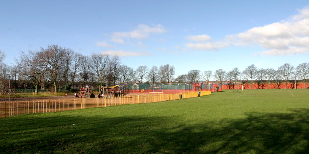 Green space and children's play area in Ribbleton Park, Preston.