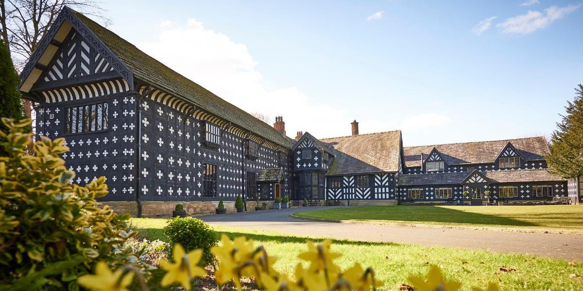 Samlesbury Hall exterior with daffodils in the foreground.