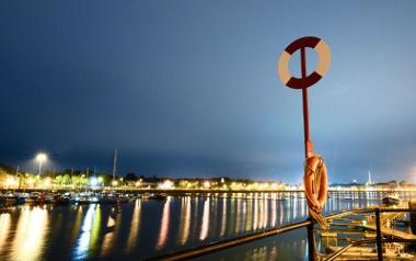 Lifebuoy and view of Preston Docks at night.