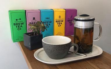 Range of teas, with strainer and cup arranged on table inside Jonah's.