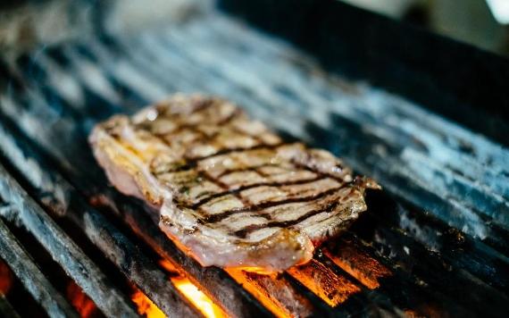 Steak on a grill inside Theatre Street restaurant.