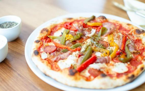 Pizza on table in Angelos, restaurant Preston.