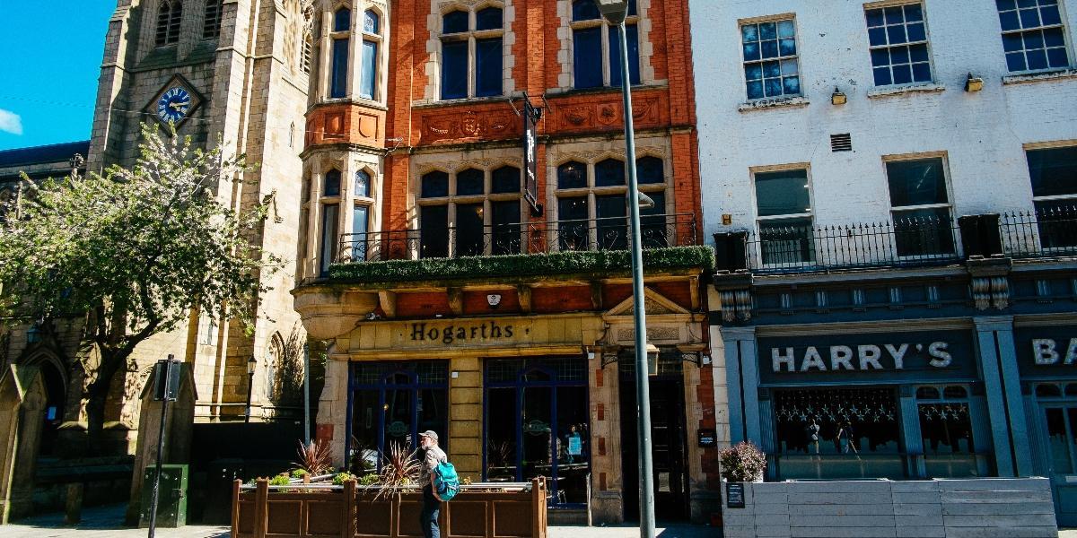 Hogarths' front entrance and outside seating on Church Street, Preston.