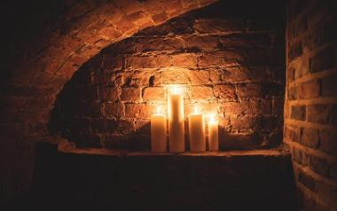 Candles lit in alcove inside PLAU's underground bar.