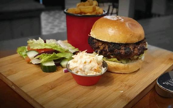 Burger and fries on wooden board from Stanley Arms.